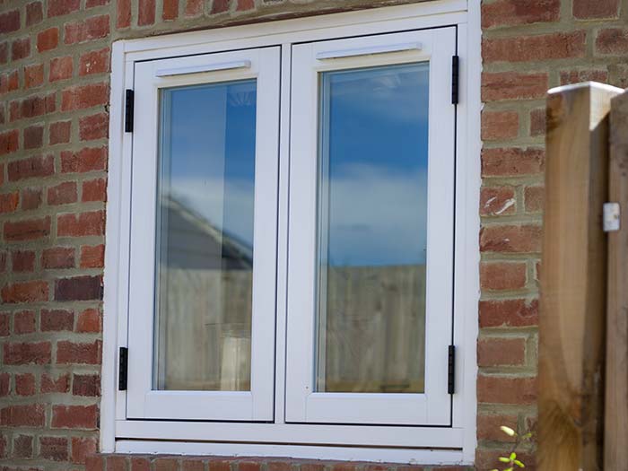 White 19th century style traditional windows made using uPVC