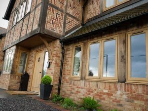 Oak effect flush sash window installation for traditional style property