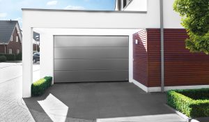 Grey garage door with red house wall