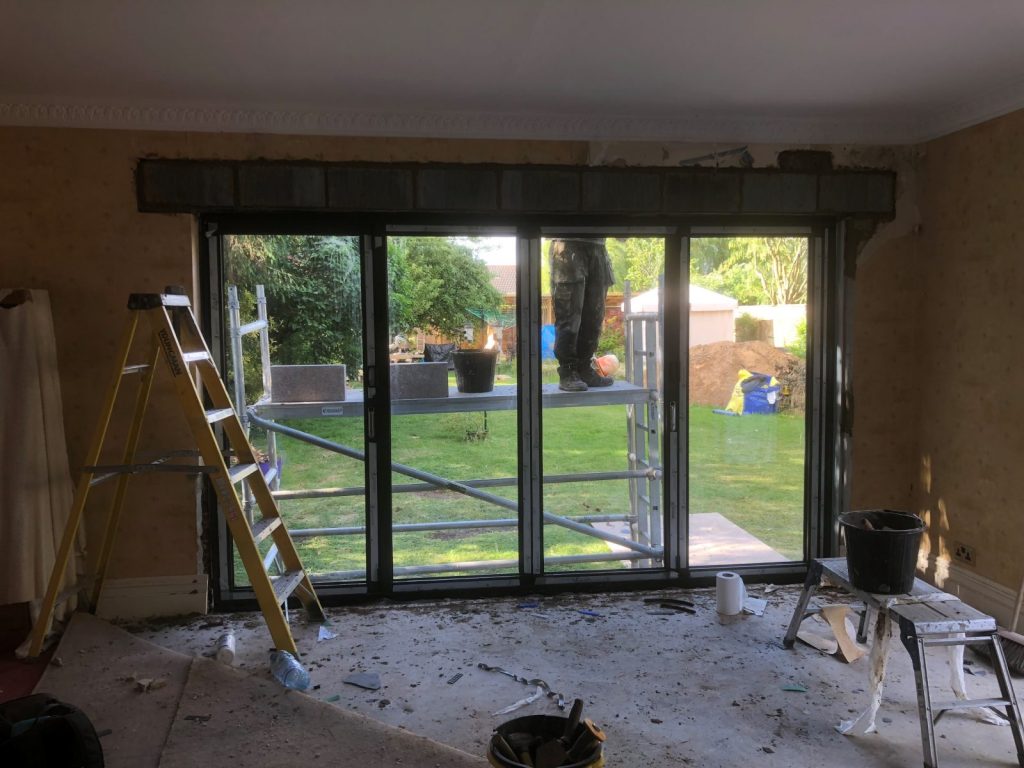 Replacing the window with new doors.