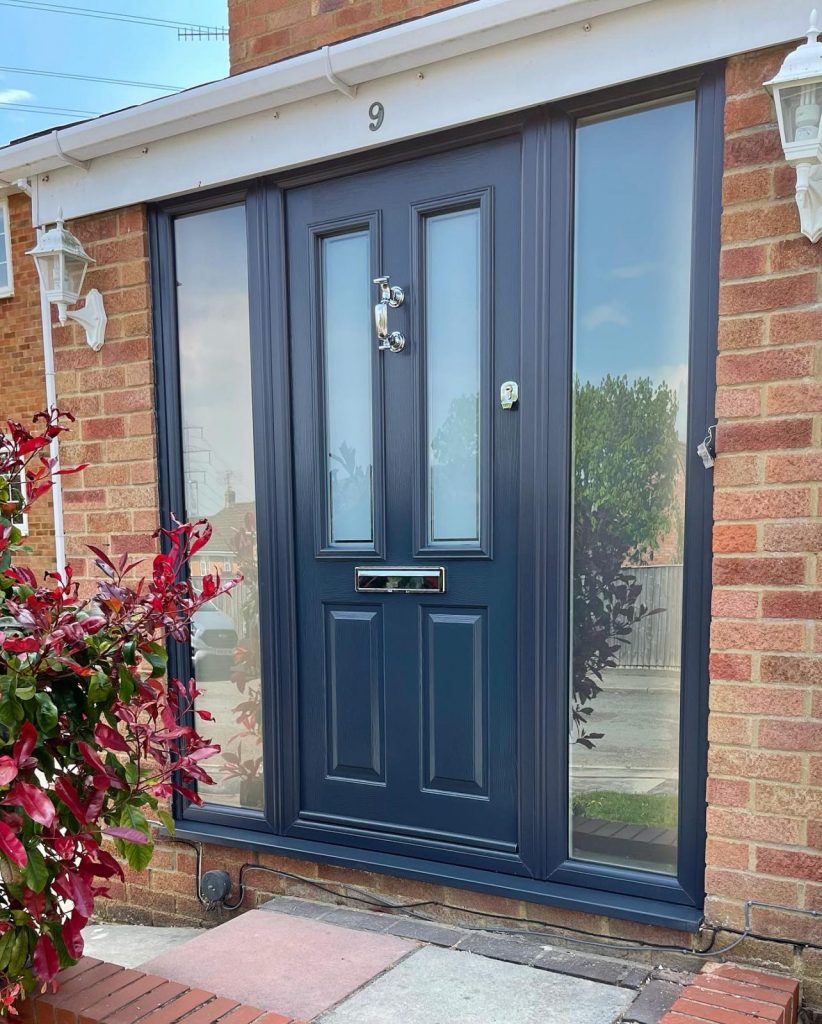 Black front door with glass side panels.