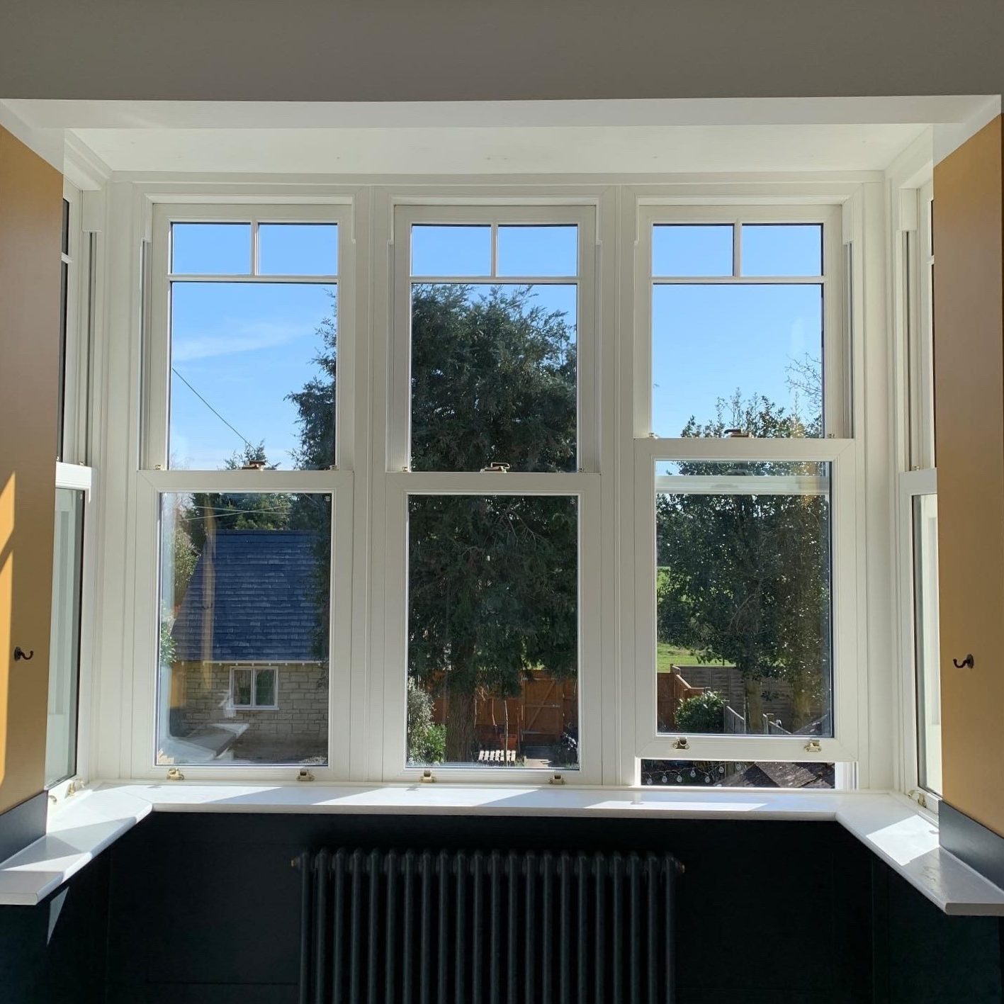 White sliding sash bay window