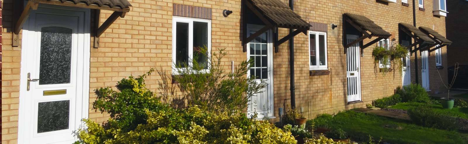 Terrace houses with white uPVC entrance doors
