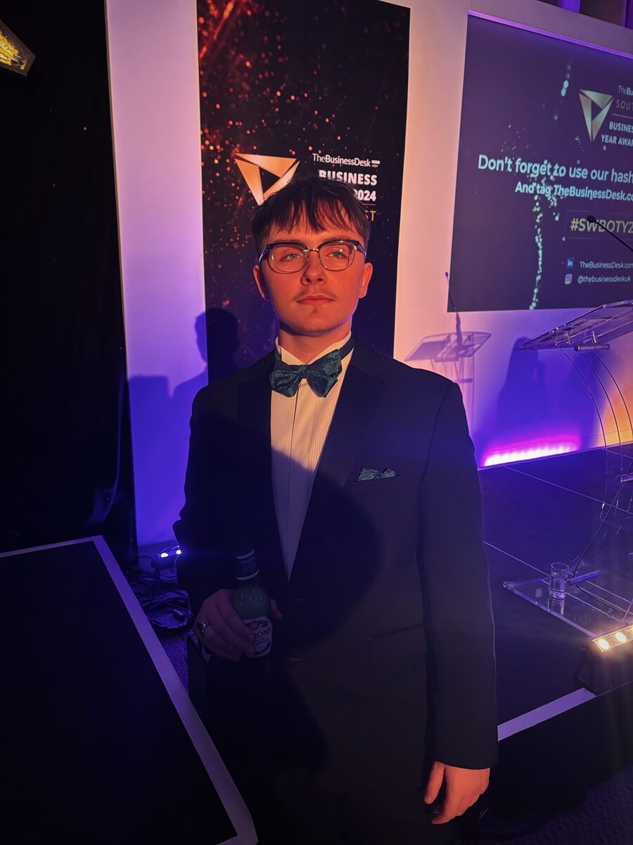 Lee Brett stands elegantly dressed in formal attire at The Business Desk South West Business Awards 2024, representing the professional excellence celebrated at this prestigious corporate event.