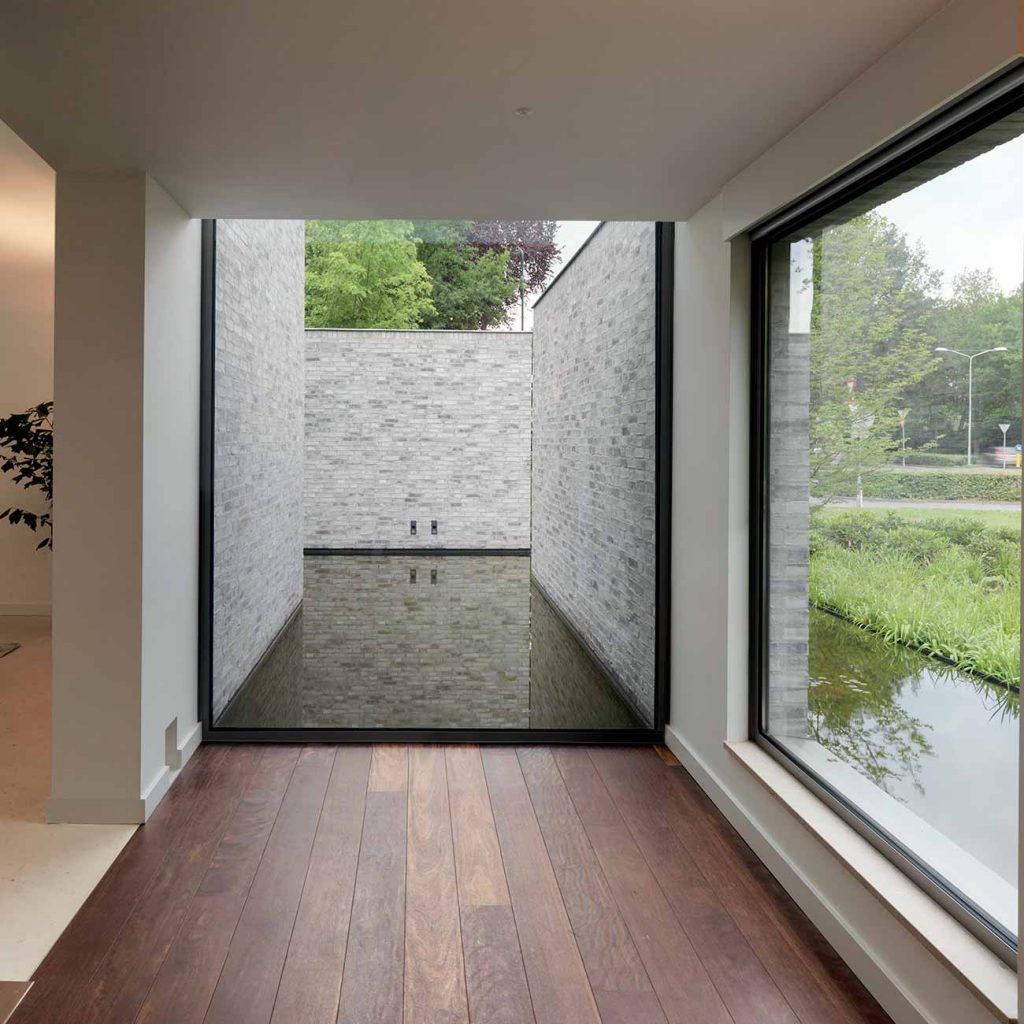A large aluminium window in a stone built luxury property
