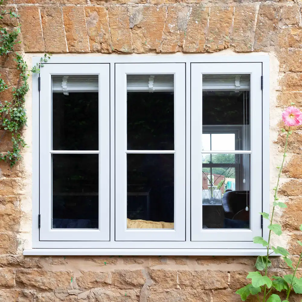 A set of casement windows surrounded by a stone wall