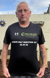 Front view of runner Nigel wearing a black running shirt sponsored by Emerald Windows for the Swindon Half Marathon